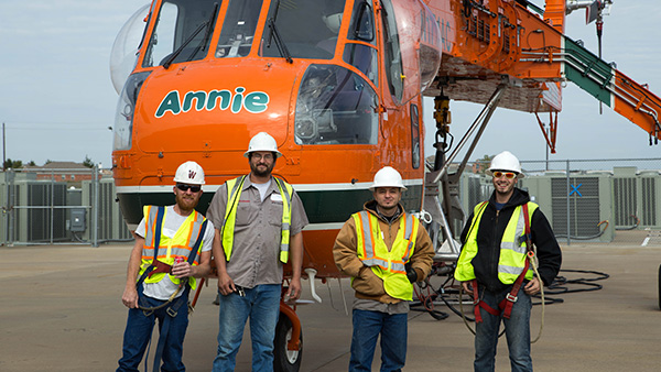 Walgreens crew working alongside a helicopter on-site.